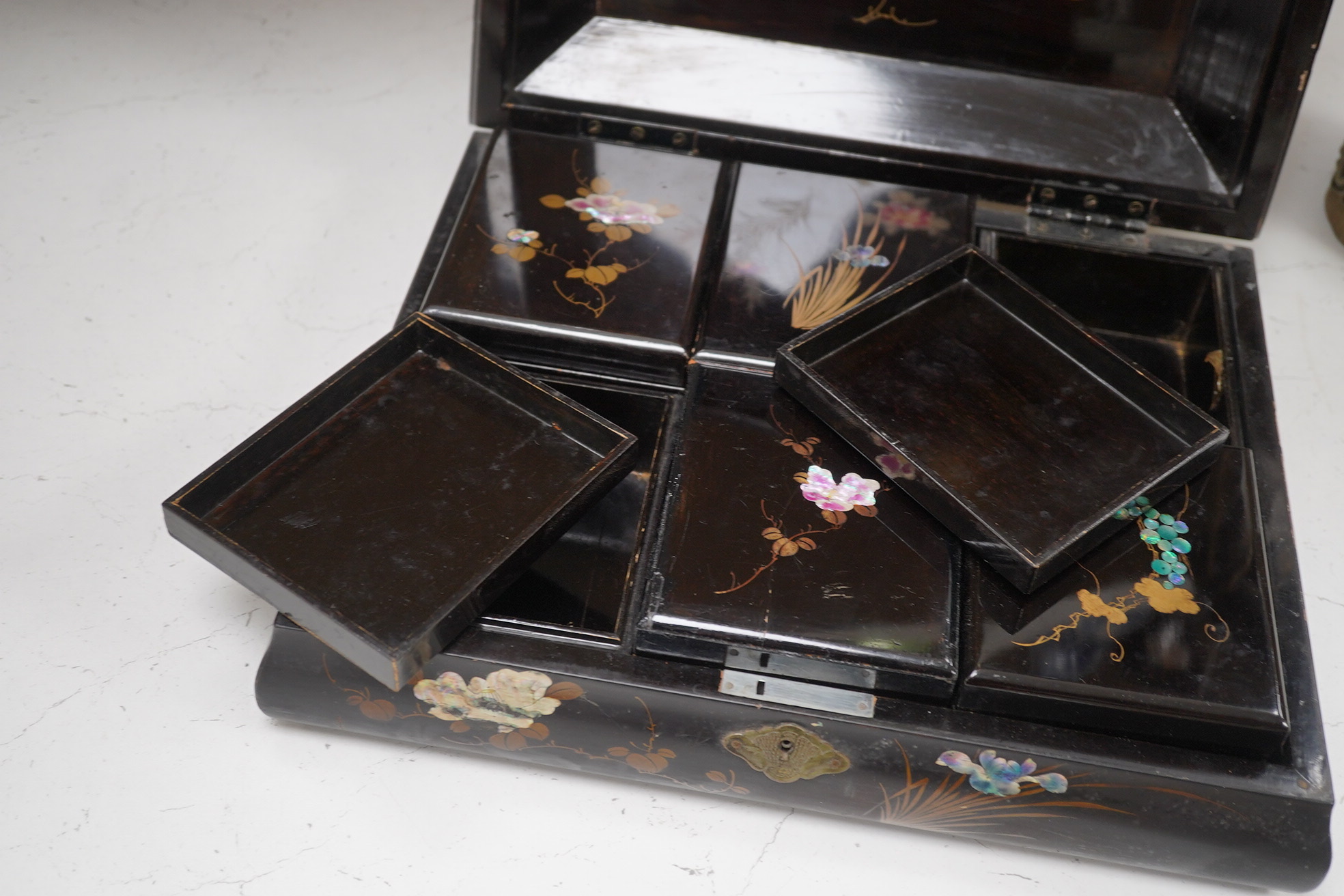 A Japanese lacquered box with mother of pearl inlay of birds and flowers, 35.5cm wide. Condition - worn on the outside to be expected, inside good